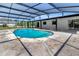 The kidney-shaped screened-in pool has easy access to the home through multiple doorways at 3380 Blossom St, Kissimmee, FL 34746