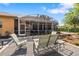 Outdoor patio with gravel, comfortable seating, and a screened enclosure, perfect for relaxing at 34021 Park Ln, Leesburg, FL 34788