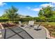 Outdoor patio area features comfortable seating on gravel with landscaping, ideal for relaxation at 34021 Park Ln, Leesburg, FL 34788