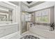 Stylish bathroom featuring a soaking tub, glass shower, and double vanity at 34021 Park Ln, Leesburg, FL 34788