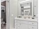 Full bath featuring all-white cabinets and fixtures, and a walk-in shower, and toilet at 34021 Park Ln, Leesburg, FL 34788