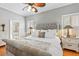 Relaxing bedroom with hardwood floors, natural light, and a comfortable bed at 34021 Park Ln, Leesburg, FL 34788