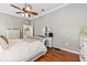 Cozy bedroom featuring hardwood floors, and a comfortable bed with crisp white bedding at 34021 Park Ln, Leesburg, FL 34788