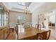 Bright dining room with beautiful wood floors, modern light fixture, and large window at 34021 Park Ln, Leesburg, FL 34788