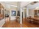 Foyer view showcasing hardwood floors, decor accents and natural light, leading into dining and living areas at 34021 Park Ln, Leesburg, FL 34788