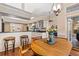 Bright breakfast nook featuring a wooden table, bar seating, and a well-equipped kitchen at 34021 Park Ln, Leesburg, FL 34788