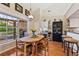 Inviting dining area with a wooden table, an airy atmosphere, and views of the backyard at 34021 Park Ln, Leesburg, FL 34788