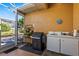 Outdoor kitchen features a built-in grill, sink, and prep area with access to the backyard at 34021 Park Ln, Leesburg, FL 34788