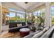 Cozy sunroom with plenty of natural light, comfortable seating, and serene decor at 34021 Park Ln, Leesburg, FL 34788