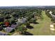 Aerial view of the property within a golf course community with lush greenery and mature trees at 3706 Doune Way, Clermont, FL 34711
