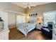 Bright bedroom with vaulted ceilings, a ceiling fan, plank floors, and access to natural light at 3706 Doune Way, Clermont, FL 34711