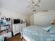 Bedroom with plank floors, a ceiling fan, a TV, and lots of natural light at 3706 Doune Way, Clermont, FL 34711
