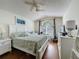 Bedroom with plank floors, vaulted ceilings, a large window, and a light neutral color scheme at 3706 Doune Way, Clermont, FL 34711