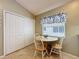 Cozy eat-in area with natural light, a charming table and white chairs next to pantry at 3706 Doune Way, Clermont, FL 34711