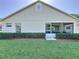 Back exterior shows a well-maintained yard and patio of this charming home at 3706 Doune Way, Clermont, FL 34711