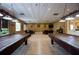 Spacious game room featuring two pool tables, neutral colors, and abundant lighting for endless hours of entertainment at 3706 Doune Way, Clermont, FL 34711