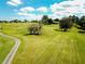 Scenic aerial view of the lush green golf course, featuring mature trees and serene fairways at 3706 Doune Way, Clermont, FL 34711