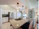 Modern kitchen featuring granite countertops, stainless steel appliances, and an island with seating at 3706 Doune Way, Clermont, FL 34711