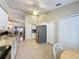 Spacious kitchen featuring granite countertops, a stainless steel refrigerator, and ample cabinet space at 3706 Doune Way, Clermont, FL 34711