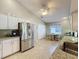 Bright eat-in kitchen with stainless steel refrigerator, tile floors and granite countertops at 3706 Doune Way, Clermont, FL 34711