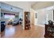 Inviting living room with warm hardwood floors, and a view into the well-lit foyer at 3706 Doune Way, Clermont, FL 34711
