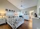 Well-lit main bedroom featuring an ensuite bathroom, plank floors, and vaulted ceilings at 3706 Doune Way, Clermont, FL 34711