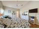 Spacious main bedroom with a TV, vaulted ceilings, a ceiling fan, and plank floors at 3706 Doune Way, Clermont, FL 34711