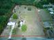 Expansive property featuring a home, large open land area, and mature trees, marked with a boundary line at 37149 Grays Airport, Lady Lake, FL 32159