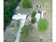 An aerial view of a cozy home with a long driveway and spacious yard, nestled among lush trees at 37149 Grays Airport, Lady Lake, FL 32159