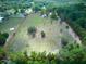 Aerial view of property showcasing a large lot with multiple structures and grassy areas at 37149 Grays Airport, Lady Lake, FL 32159