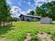 A fenced backyard with metal storage shed and lush green grass at 37149 Grays Airport, Lady Lake, FL 32159