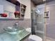 Modern bathroom featuring glass sink bowl, sleek fixtures, tiled walls and shower, and minimalist decor at 37149 Grays Airport, Lady Lake, FL 32159