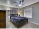 Bedroom with ceiling fan, wood-look flooring, neutral colors, and a decorative accent wall hanging at 37149 Grays Airport, Lady Lake, FL 32159