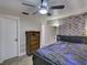 Bedroom with wood-look floors, ceiling fan and accent wall hanging at 37149 Grays Airport, Lady Lake, FL 32159