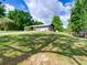 Charming single story house features a lush green lawn with mature trees and long private drive at 37149 Grays Airport, Lady Lake, FL 32159