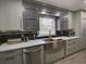 Modern kitchen with stainless steel appliances, sleek cabinetry, quartz countertops, and a stainless steel farmhouse sink at 37149 Grays Airport, Lady Lake, FL 32159