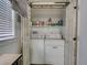 Laundry room with washer, dryer, open shelving and rustic doors at 37149 Grays Airport, Lady Lake, FL 32159