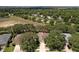 This aerial view shows the house surrounded by lush greenery and trees at 3732 Fallscrest Cir, Clermont, FL 34711