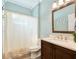 This charming bathroom features a single vanity, white sink, and a shower with a curtain at 3732 Fallscrest Cir, Clermont, FL 34711