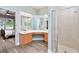 Bright bathroom featuring double vanity sinks, and glass-enclosed shower at 3732 Fallscrest Cir, Clermont, FL 34711