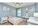 This lovely bedroom includes a ceiling fan, and is decorated with unique artwork and a vanity at 3732 Fallscrest Cir, Clermont, FL 34711