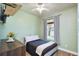 This cozy bedroom includes a ceiling fan, and has a view outside and a dark wood dresser at 3732 Fallscrest Cir, Clermont, FL 34711