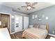 This cozy bedroom includes a ceiling fan, and has artwork and a double mirrored closet at 3732 Fallscrest Cir, Clermont, FL 34711
