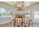 Charming dining room with a stone fireplace, ample natural light, and a view of the backyard at 3732 Fallscrest Cir, Clermont, FL 34711