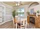 Cozy dining room featuring a stone fireplace, ample natural light, and a view of the backyard at 3732 Fallscrest Cir, Clermont, FL 34711