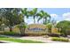 Community entrance sign for Somerset Estates, surrounded by lush landscaping and palm trees at 3732 Fallscrest Cir, Clermont, FL 34711