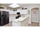 Bright kitchen features white cabinets, stainless steel appliances, and a neutral color scheme at 3732 Fallscrest Cir, Clermont, FL 34711