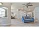 Open-concept living room featuring wood-look floors, modern ceiling fan, and seamless flow into the kitchen at 3732 Fallscrest Cir, Clermont, FL 34711