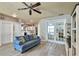 Spacious living area featuring a comfortable sofa, seamless flow into the kitchen, and neutral paint colors at 3732 Fallscrest Cir, Clermont, FL 34711