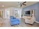 Open living space with wood-look floors, comfortable seating, and french doors leading to the backyard at 3732 Fallscrest Cir, Clermont, FL 34711